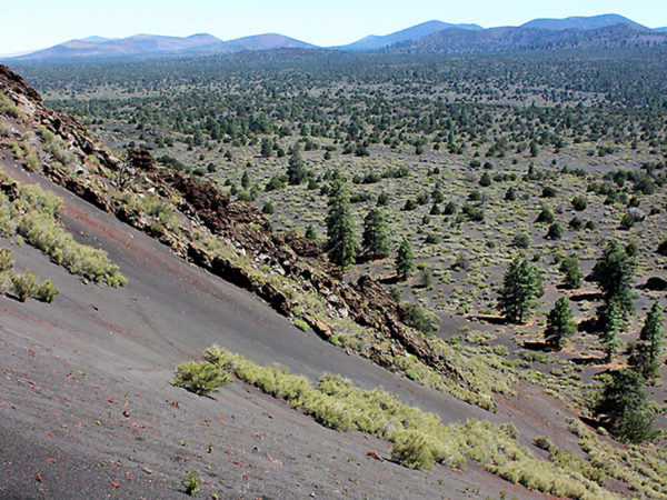Landscape view of the loose lava on the side of Strawberry Crater; north of Flagstaff; Arizona. With the Sunset Crater Mountains in the distance. Taken from the Strawberry Crater Hiking Trail Loop. Copyright azutopia. No use without permission.