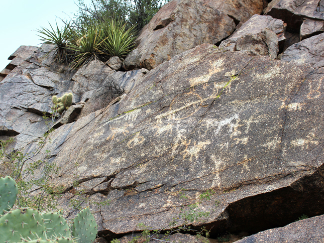 A landscape view of ancient, Native American hieroglyphs on a canyon wall by the banks of the Aqua Fria River, in Aqua Fria National Monument, off the Badger Springs Hiking Trail, near Bumblebee, Arizona. Phoenix area hiking trails. Easy Arizona Hiking trails. Family friendly hiking trails. Dog friendly hiking trails. Copyright azutopia.com. No use without permission.