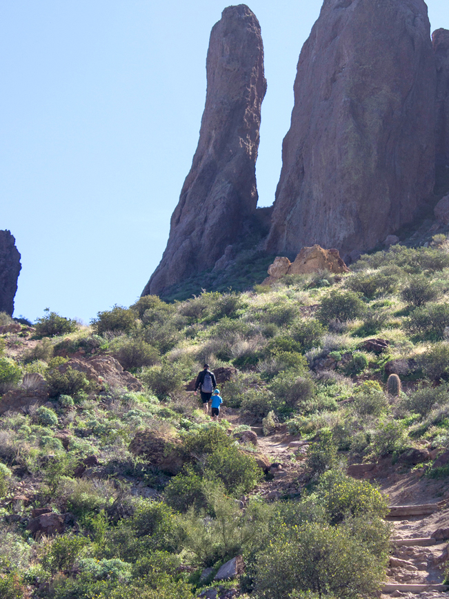 Hikers; Fathe and Son; Treasure Trail Hiking Loop; At base of Praying Hands Rock Formation; Lost Dutchman State Park; Superstition Mountains; Arizona; Cliffs; Copyright azutopia.com. No use without permission.