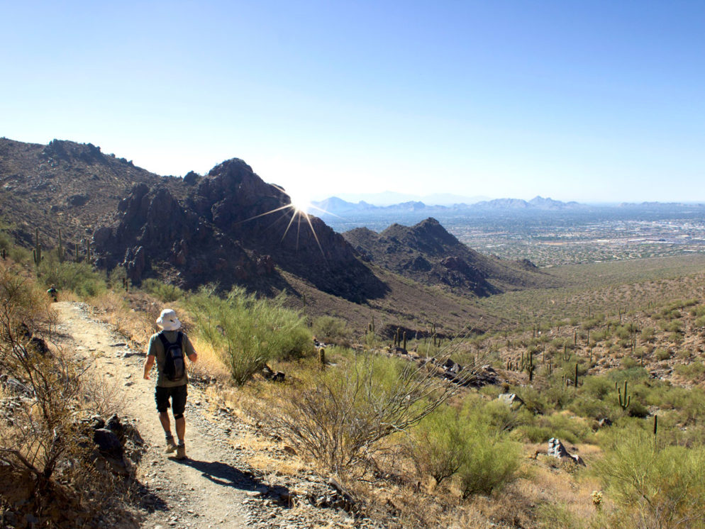 Hiker; Bell Pass Hiking Trail; Phoenix Area; Arizona; McDowell Mountains; Pass; Mountaintop; Scottsdale; Mountains; Saquaros; Rocky Outcropping; View; Camelback Mountain; Piestewa Peak; Difficult Hiking Trails; Copyright azutopia.com. No use without permission.