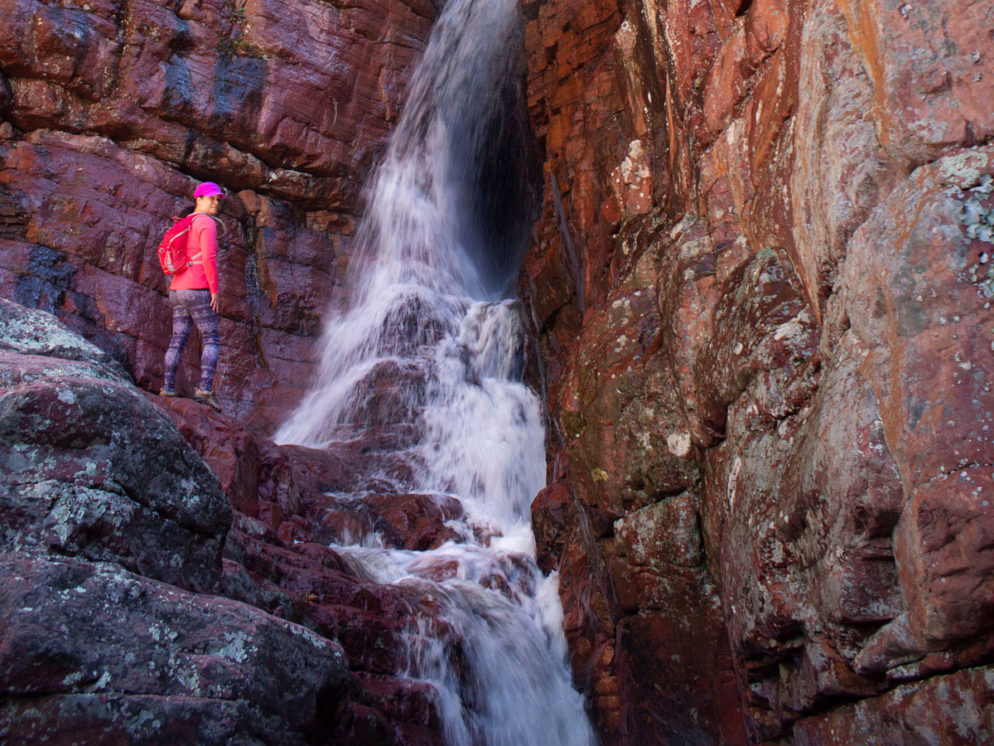Hiker; Waterfall; Spring Snowmelt; Red Cliffs; Rocks; Matzatzal Mountains; Barnhardt Hiking Trail; Payson; Arizona; Difficult Hiking Trails. Copyright azutopia.com. No use without permission.