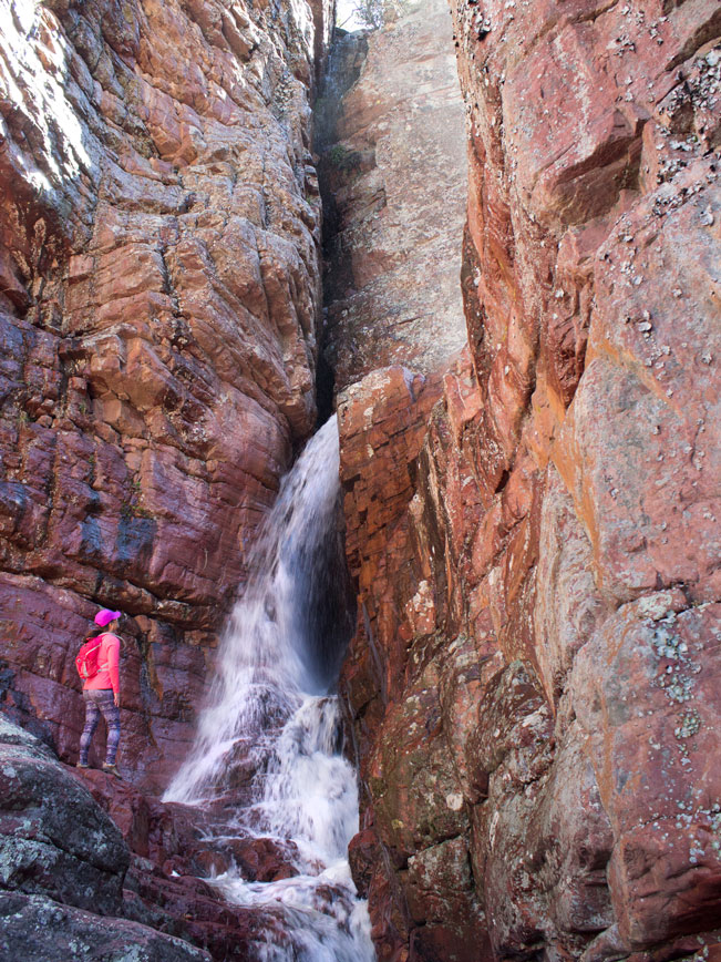 Hiker; Waterfall; Spring Snowmelt; Red Cliffs; Barnhardt Hiking Trail; Matzatzal Mountains; Payson; Arizona; Difficult Hiking Trails. Copyright azutopia.com. No use without permission.